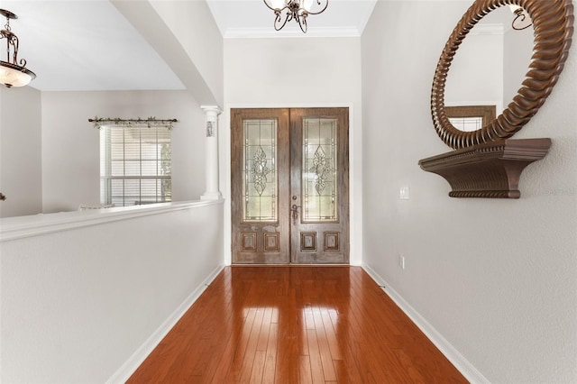 2702 Rogers Ranch Rd, Lithia, FL 33547 - entryway with french doors, wood-type flooring, a chandelier, and crown molding