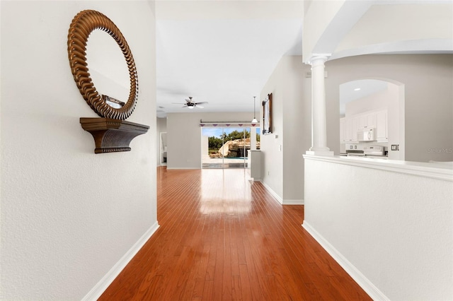 2702 Rogers Ranch Rd, Lithia, FL 33547 - corridor with decorative columns, wood-type flooring, and arched walkways