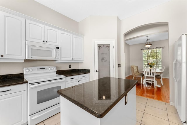 2702 Rogers Ranch Rd, Lithia, FL 33547 - kitchen with white appliances, white cabinetry, and arched walkways