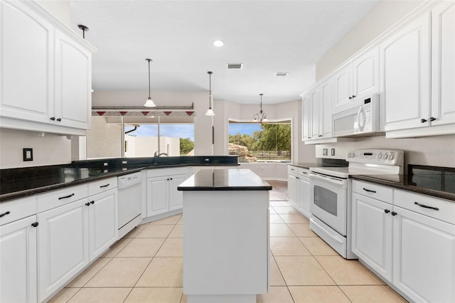 2702 Rogers Ranch Rd, Lithia, FL 33547 - kitchen with white appliances, a kitchen island, dark countertops, white cabinetry, and hanging light fixtures