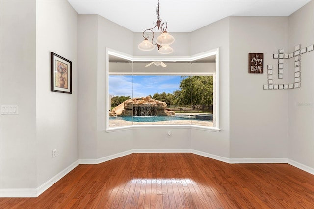 2702 Rogers Ranch Rd, Lithia, FL 33547 - spare room featuring hardwood / wood-style flooring and a chandelier