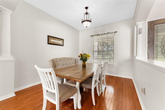 2702 Rogers Ranch Rd, Lithia, FL 33547 - dining room featuring decorative columns and hardwood / wood-style flooring