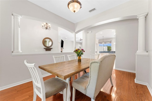 2702 Rogers Ranch Rd, Lithia, FL 33547 - dining area with ornate columns, light wood-style flooring, and arched walkways