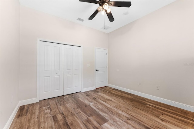 2702 Rogers Ranch Rd, Lithia, FL 33547 - unfurnished bedroom with wood finished floors, a closet, and a ceiling fan