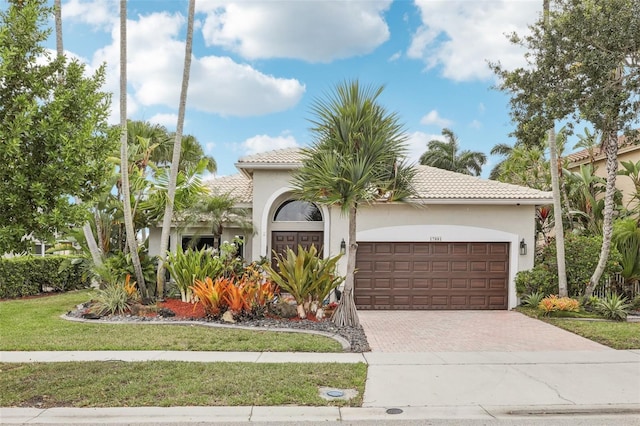 17001 NW 20th St, Pembroke Pines, FL 33028 - mediterranean / spanish house with a garage, a tile roof, decorative driveway, and stucco siding