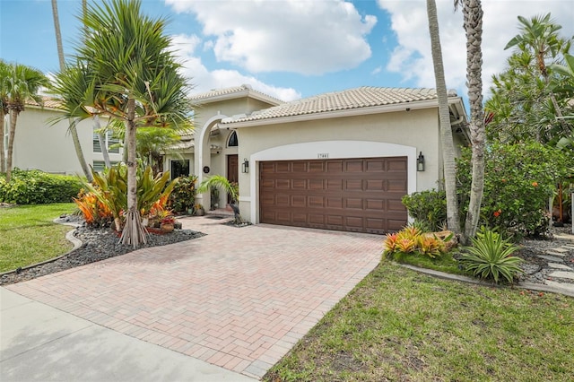 17001 NW 20th St, Pembroke Pines, FL 33028 - mediterranean / spanish-style home featuring decorative driveway, stucco siding, an attached garage, and a front lawn
