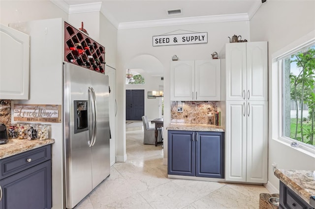 17001 NW 20th St, Pembroke Pines, FL 33028 - kitchen featuring stainless steel refrigerator with ice dispenser, light marble finish floors, backsplash, ornamental molding, and white cabinetry