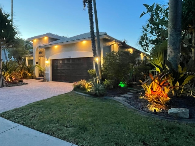 17001 NW 20th St, Pembroke Pines, FL 33028 - view of home's exterior featuring a garage, stucco siding, decorative driveway, a yard, and a tiled roof