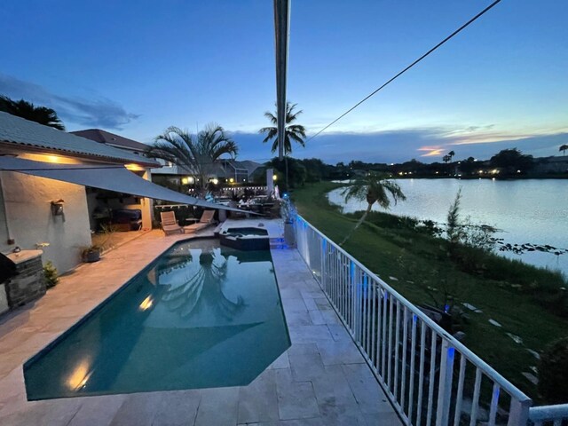17001 NW 20th St, Pembroke Pines, FL 33028 - pool at dusk with a pool with connected hot tub, a water view, and a patio
