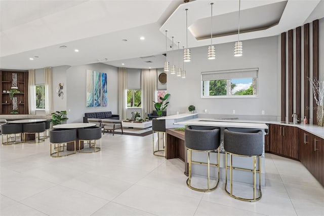 17001 NW 20th St, Pembroke Pines, FL 33028 - interior space featuring open floor plan, light countertops, modern cabinets, a breakfast bar, and recessed lighting