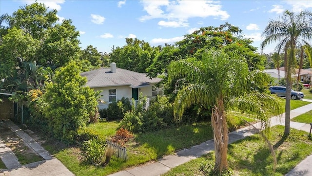 1222 Palm St, Clearwater, FL 33755 - view of front of home featuring stucco siding, a shingled roof, and a chimney