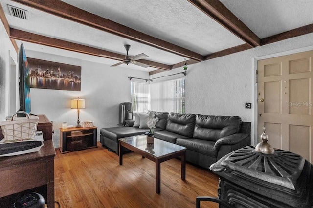 1222 Palm St, Clearwater, FL 33755 - living room featuring beam ceiling, wood finished floors, a textured wall, and ceiling fan
