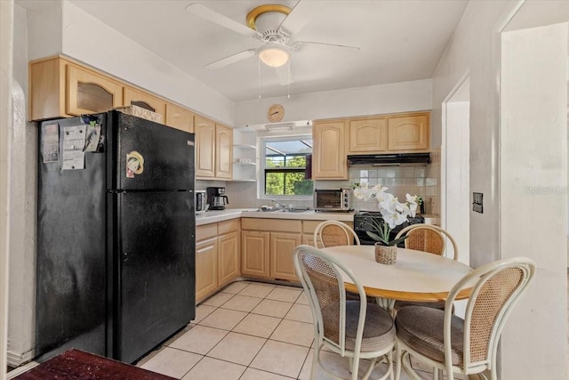 1222 Palm St, Clearwater, FL 33755 - kitchen featuring freestanding refrigerator, light brown cabinets, ceiling fan, light tile patterned floors, and light countertops