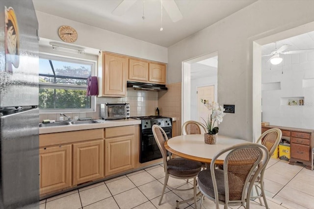 1222 Palm St, Clearwater, FL 33755 - kitchen featuring freestanding refrigerator, a ceiling fan, gas stove, light brown cabinets, and under cabinet range hood