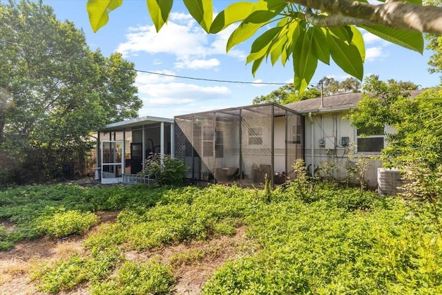 1222 Palm St, Clearwater, FL 33755 - back of property with stucco siding and a lanai