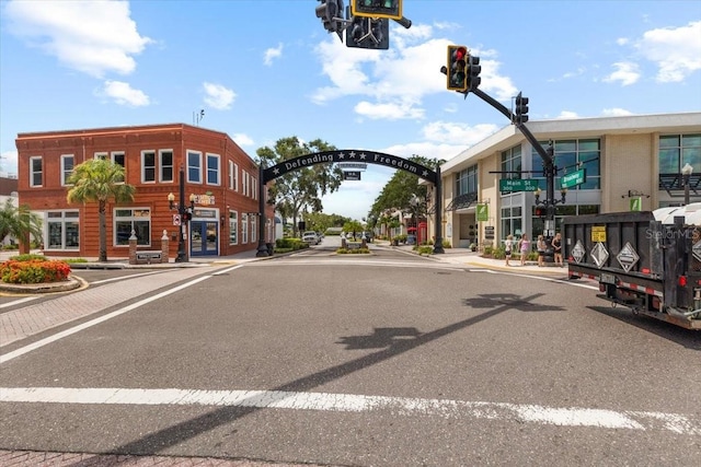 1222 Palm St, Clearwater, FL 33755 - view of asphalt street featuring traffic lights, sidewalks, curbs, street lighting, and traffic signs