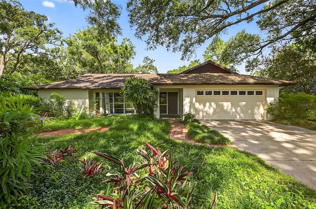 524 Garrard Dr, Temple Terrace, FL 33617 - ranch-style home featuring driveway, stucco siding, and a garage