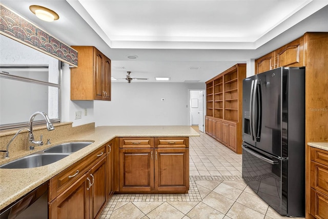524 Garrard Dr, Temple Terrace, FL 33617 - kitchen with black fridge, dishwasher, a raised ceiling, and a peninsula