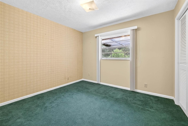 524 Garrard Dr, Temple Terrace, FL 33617 - unfurnished bedroom featuring a textured ceiling, dark colored carpet, a closet, and wallpapered walls