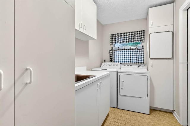 524 Garrard Dr, Temple Terrace, FL 33617 - laundry room with washer and clothes dryer, cabinet space, and a textured ceiling