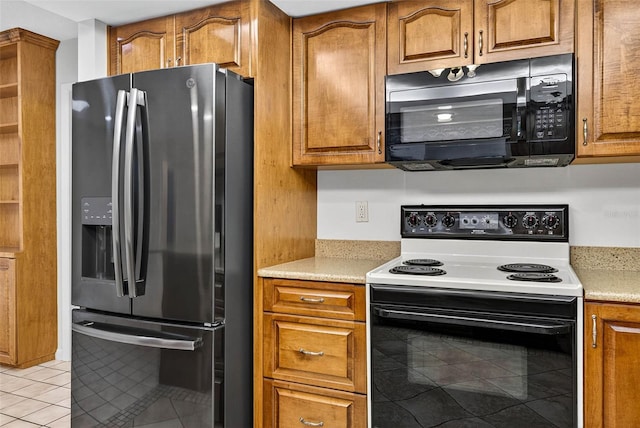524 Garrard Dr, Temple Terrace, FL 33617 - kitchen featuring black appliances, light tile patterned floors, and brown cabinets