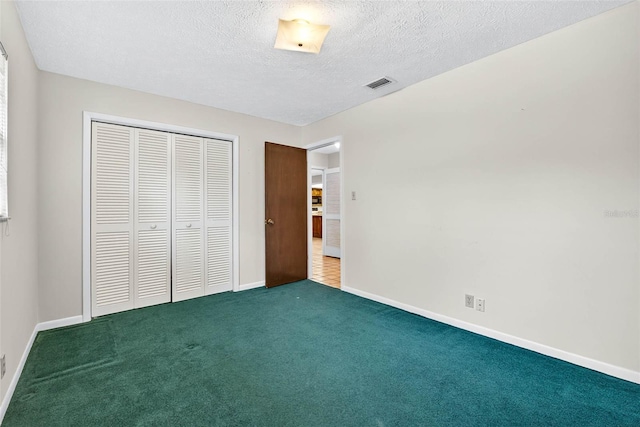 524 Garrard Dr, Temple Terrace, FL 33617 - unfurnished bedroom with carpet floors, a closet, and a textured ceiling
