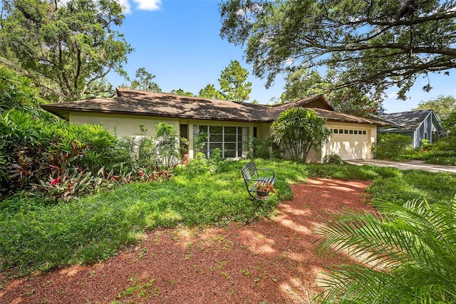 524 Garrard Dr, Temple Terrace, FL 33617 - view of front of house with driveway, an attached garage, and stucco siding