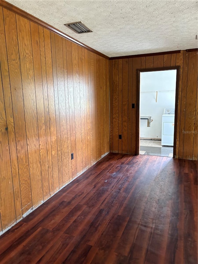 1214 Mitchell St, Brandon, FL 33511 - unfurnished room with washer / clothes dryer, hardwood / wood-style floors, wooden walls, and a textured ceiling