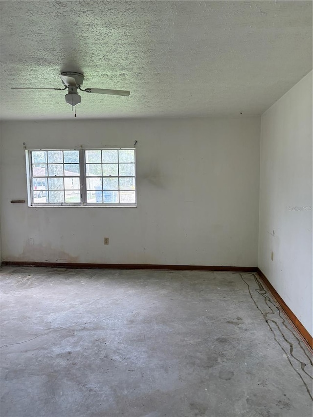 1214 Mitchell St, Brandon, FL 33511 - empty room with unfinished concrete flooring, a textured ceiling, and a ceiling fan