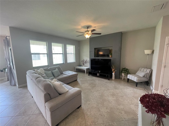 1596 Ludington Ave, Wesley Chapel, FL 33543 - living area with ceiling fan, light tile patterned floors, and a textured ceiling
