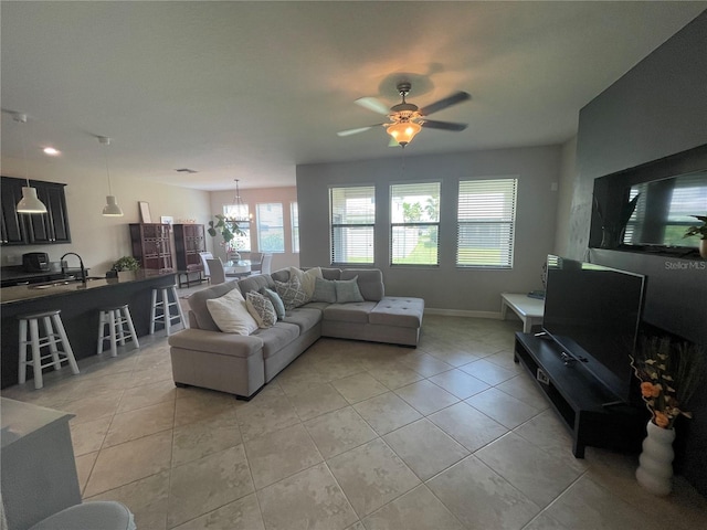 1596 Ludington Ave, Wesley Chapel, FL 33543 - living area featuring plenty of natural light, light tile patterned floors, a chandelier, and a ceiling fan