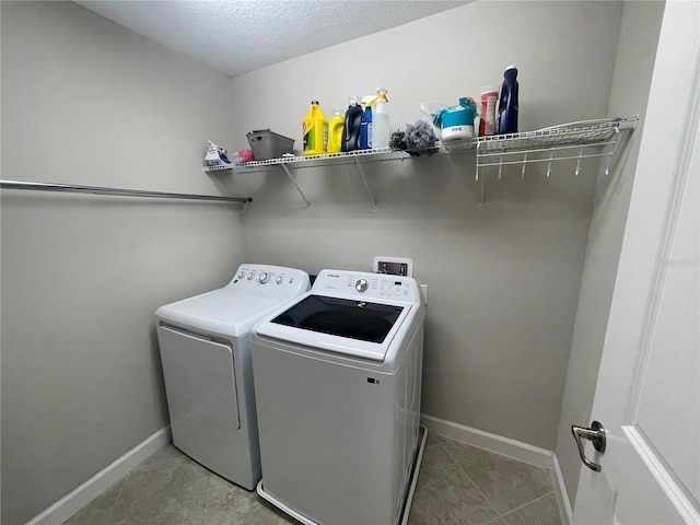 1596 Ludington Ave, Wesley Chapel, FL 33543 - laundry area with washing machine and clothes dryer, tile patterned floors, and a textured ceiling