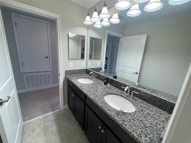1596 Ludington Ave, Wesley Chapel, FL 33543 - full bathroom featuring double vanity, a chandelier, and tile patterned floors