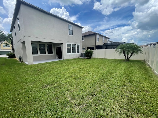 1596 Ludington Ave, Wesley Chapel, FL 33543 - back of house featuring a patio area, a fenced backyard, and stucco siding