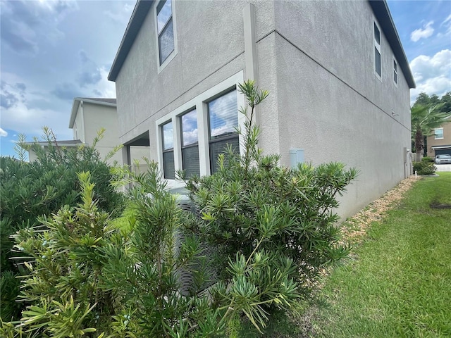 1596 Ludington Ave, Wesley Chapel, FL 33543 - view of property exterior with stucco siding