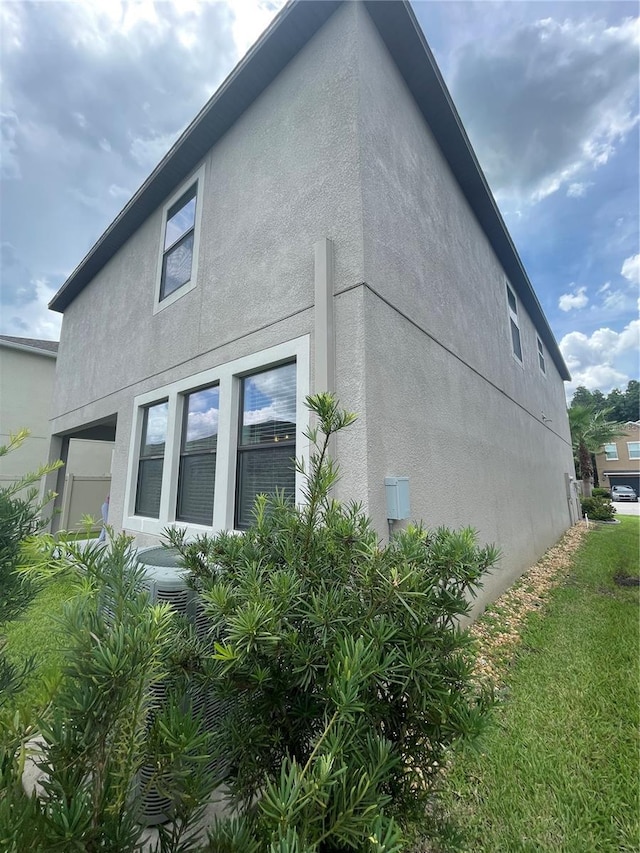 1596 Ludington Ave, Wesley Chapel, FL 33543 - view of property exterior with stucco siding