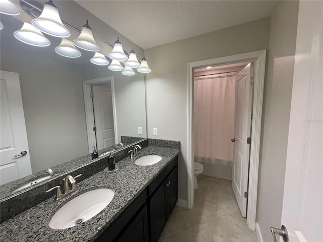 1596 Ludington Ave, Wesley Chapel, FL 33543 - full bath with double vanity, a textured ceiling, tile patterned floors, and shower / tub combo