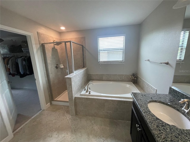 1596 Ludington Ave, Wesley Chapel, FL 33543 - bathroom with a bath, vanity, a shower stall, and a spacious closet