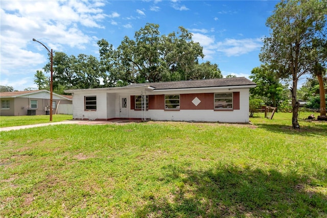 603 Clay Ct, Brandon, FL 33510 - ranch-style home featuring a front lawn, a patio area, and stucco siding