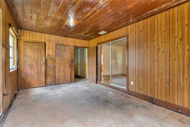 603 Clay Ct, Brandon, FL 33510 - spare room featuring unfinished concrete flooring and wooden walls