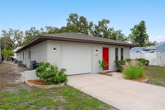 5217 29th Ave S, Gulfport, FL 33707 - view of front of home with stucco siding, driveway, a garage, and a shingled roof