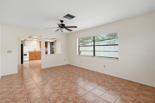 5217 29th Ave S, Gulfport, FL 33707 - empty room featuring ceiling fan and light tile patterned floors