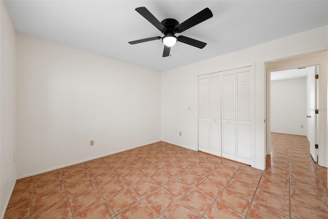 5217 29th Ave S, Gulfport, FL 33707 - unfurnished bedroom with a closet, ceiling fan, and light tile patterned flooring
