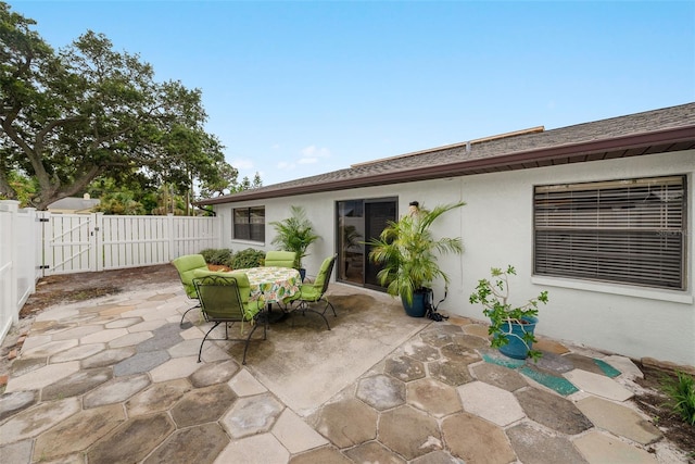 5217 29th Ave S, Gulfport, FL 33707 - fenced backyard featuring a gate, a patio, and outdoor dining area