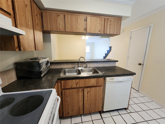 6620 121st Ave Unit 1, Largo, FL 33773 - kitchen with white appliances, under cabinet range hood, a peninsula, brown cabinets, and crown molding