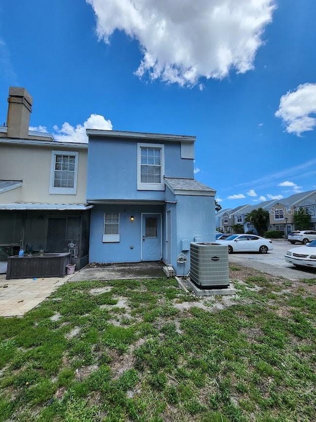 6620 121st Ave Unit 1, Largo, FL 33773 - rear view of property with stucco siding, a sunroom, and a residential view