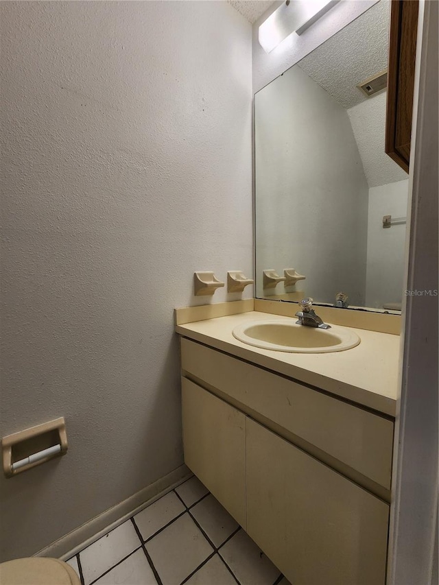 6620 121st Ave Unit 1, Largo, FL 33773 - half bathroom with vanity, tile patterned floors, lofted ceiling, and a textured ceiling