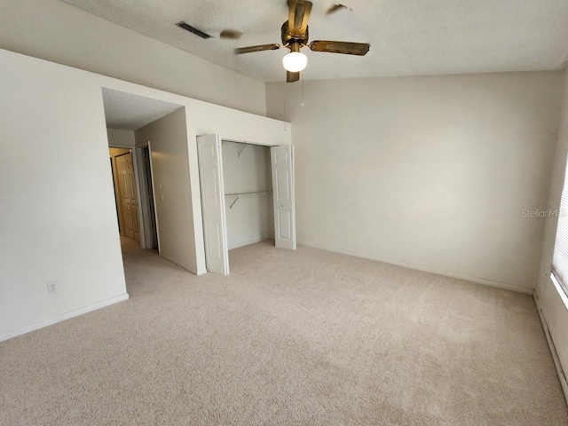 6620 121st Ave Unit 1, Largo, FL 33773 - unfurnished bedroom with light colored carpet, a closet, a textured ceiling, and a ceiling fan