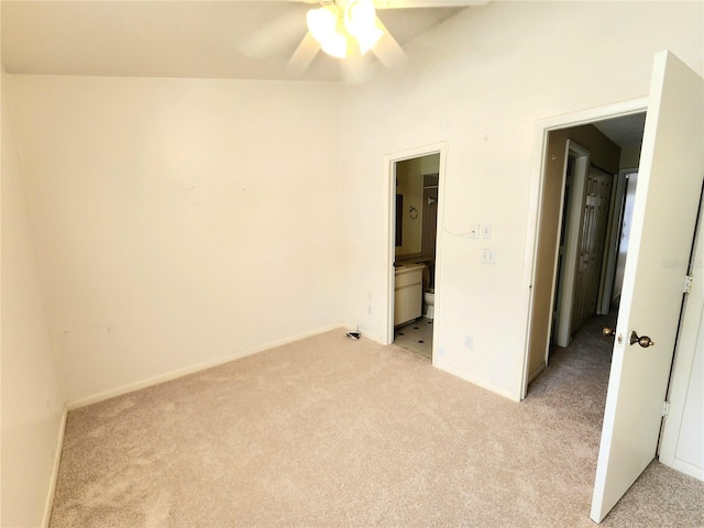 6620 121st Ave Unit 1, Largo, FL 33773 - unfurnished bedroom featuring light carpet, ensuite bathroom, and ceiling fan