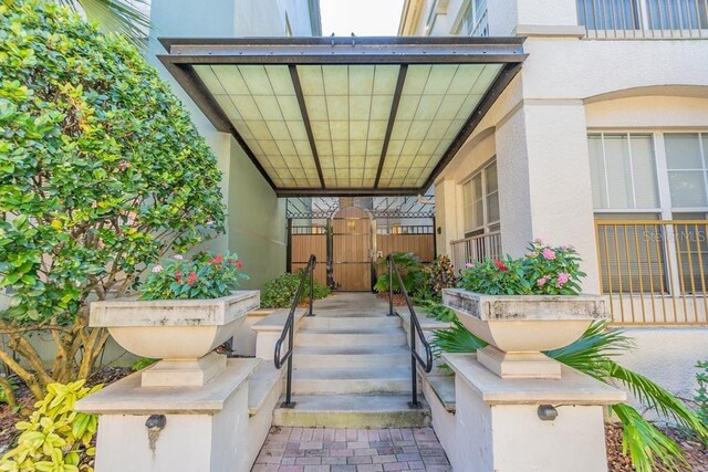 501 S Moody Ave Unit 1134, Tampa, FL 33609 - view of exterior entry with a gate and stucco siding